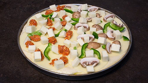 Detroit Style pizza add mozzarella cheese and sausage